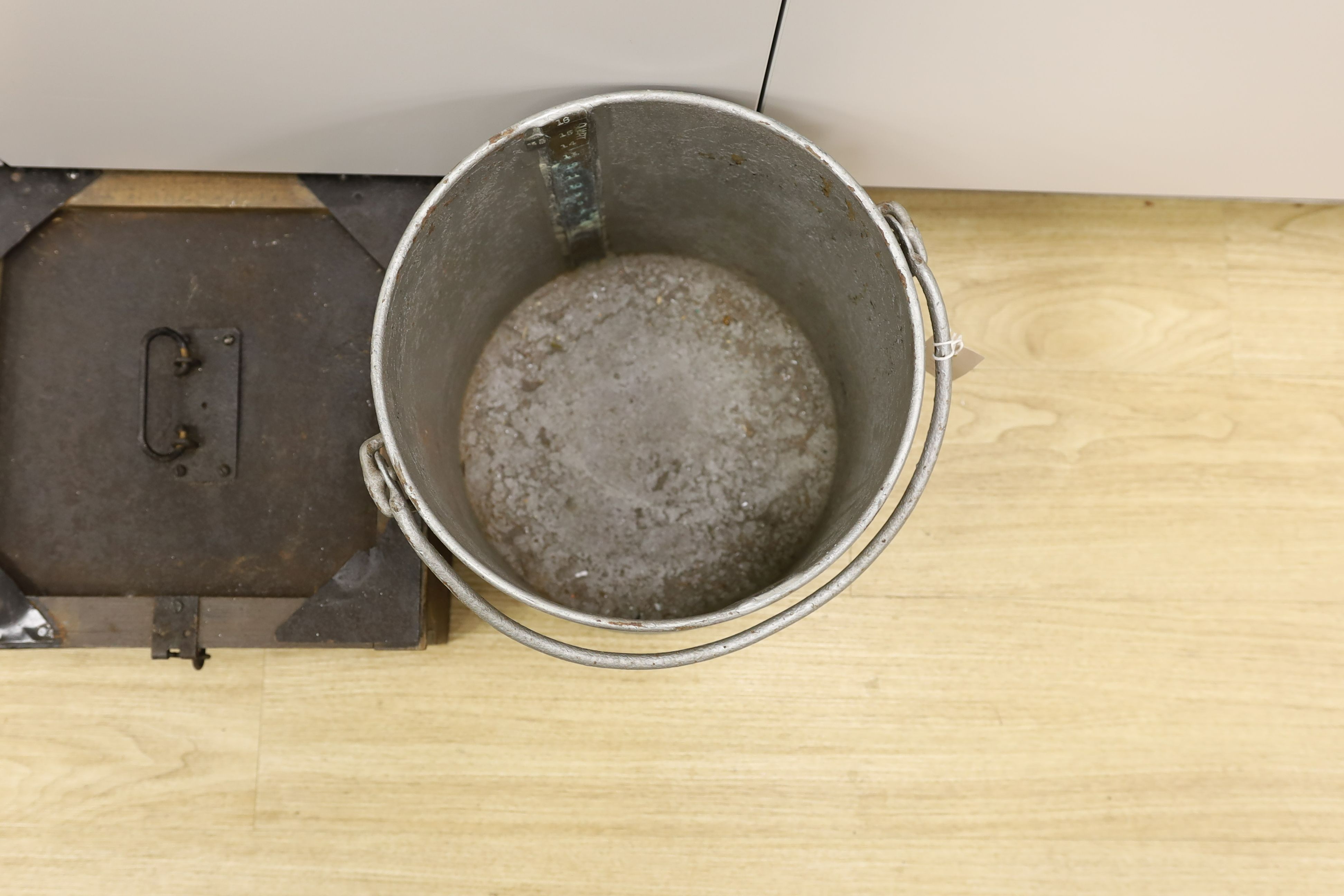 A brass mounted galvanised four gallon bucket and a case of milk sample bottles, Galvanised bucket 31 cms high.